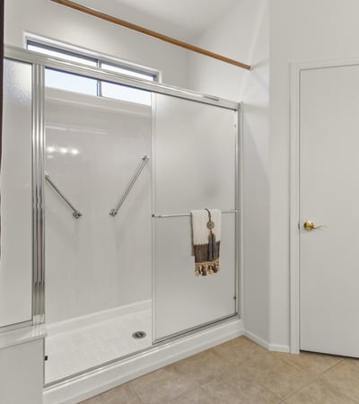 Enjoy this clean, updated bathroom featuring a large glass shower, neutral finishes, and plenty of natural light.