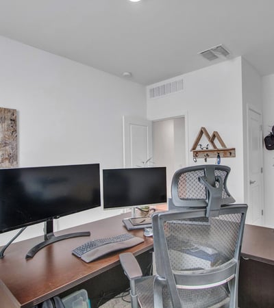 This dedicated office setup demonstrates the room s flexibility, ideal for remote work or creative space. Energy-efficient windows support comfort and productivity in this Litchfield Park home.