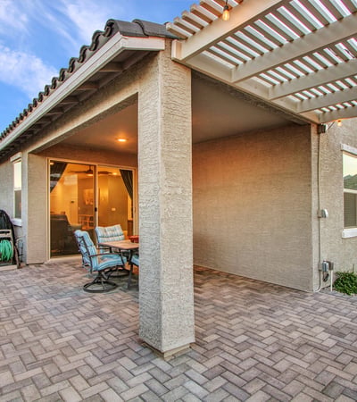 This inviting patio expands your outdoor living with a pergola, string lights, and durable pavers ideal for Litchfield Park entertaining.
