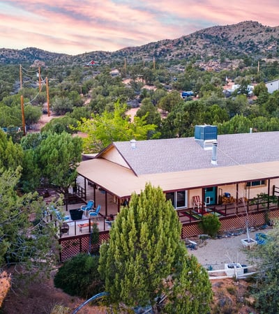 This image captures the home nestled into the surrounding desert pines, offering scenic views and outdoor tranquility. Ideal for buyers seeking a nature-focused lifestyle in Hackberry.