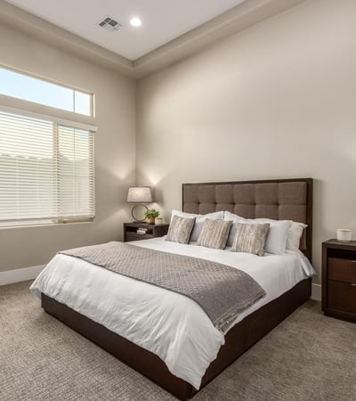 Serene primary bedroom with tall ceilings and natural light, creating a peaceful retreat within this Cave Creek residence.