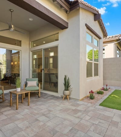 Indoor-outdoor patio area with sliding glass doors and ceiling fan, extending the living space into the backyard.