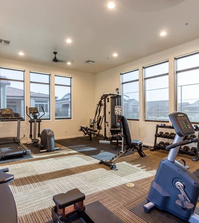 Resident fitness facility equipped with cardio and strength training machines, supporting an active lifestyle close to home.