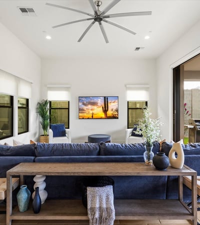 Living room with large sliding glass doors opening to the covered patio, creating true indoor-outdoor living. Designed for entertaining and enjoying Scottsdale s climate.