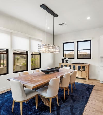Bright dining space with modern lighting and open flow to the kitchen. Ideal for entertaining guests or enjoying everyday dining in this Scottsdale luxury home.
