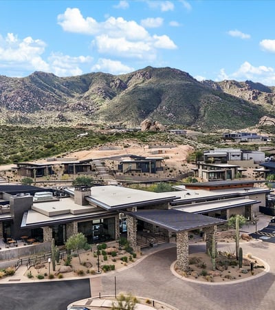 Wide aerial view capturing the scale of Sereno Canyon s clubhouse amenities, including pools, outdoor lounges, and scenic mountain backdrops.