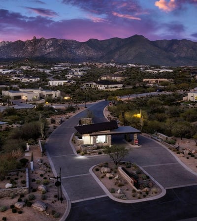Daytime aerial of the Sereno Canyon guard-gated entrance emphasizing privacy, security, and upscale access within this Scottsdale luxury community.