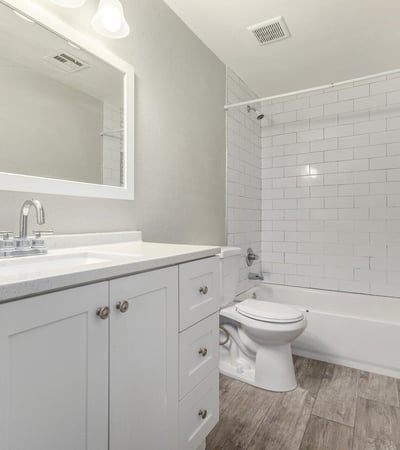 Updated full bathroom with modern vanity, large framed mirror, and subway tile shower surround clean, stylish, and ready for everyday living in Phoenix.