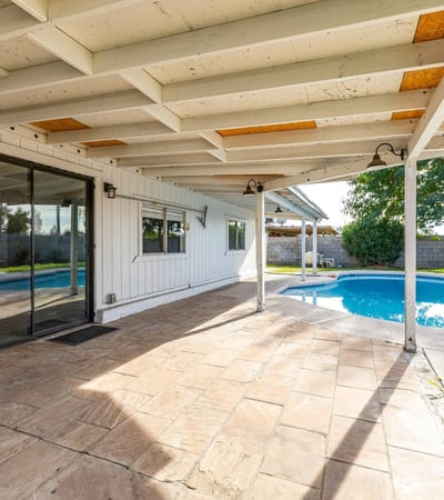 Backyard overview featuring a private pool, covered patio, and open space for lounging or play perfect for enjoying the Phoenix lifestyle and entertaining year-round.