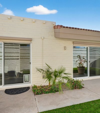 Private patio courtyard offering indoor-outdoor living, low-maintenance landscaping, and a peaceful setting.