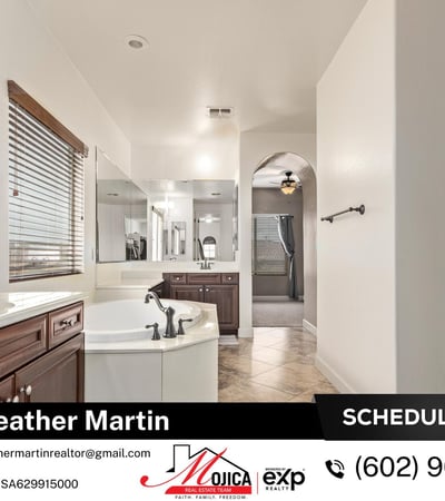 Unwind in the oversized soaking tub surrounded by extended counter space and dual sinks. A spa-like feature within this Glendale property offering modern updates and energy-efficient living.