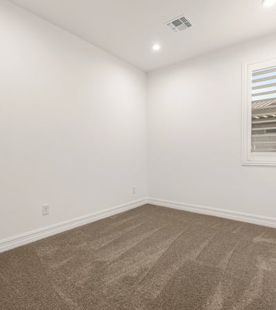 Cozy bedroom with clean finishes, soft carpet, and natural light, offering versatility for family or guests.