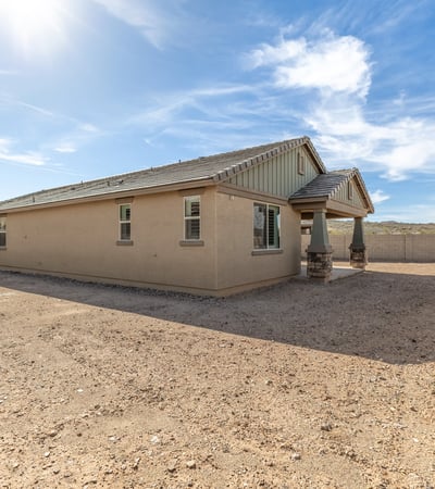 Wide backyard with privacy fencing and distant mountain views, offering a peaceful setting and room to customize.