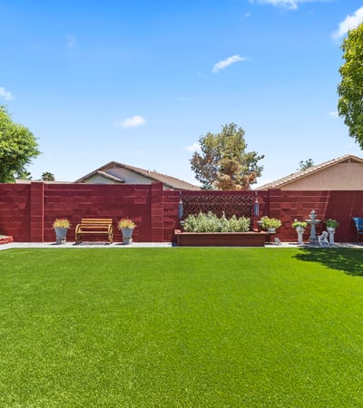 Beautifully landscaped yard with raised planters, turf lawn, and outdoor d cor. A private and inviting outdoor retreat.