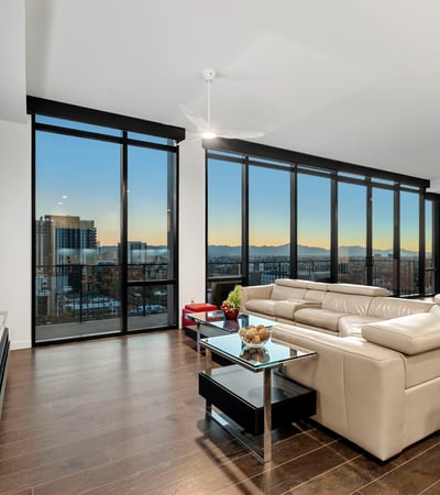 Balcony dining space with comfortable seating and breathtaking sunset views over Phoenix, perfect for hosting or unwinding.