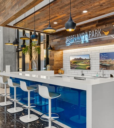 Modern lobby bar with clean lines, pendant lighting, and comfortable seating, offering a stylish gathering space in Phoenix.