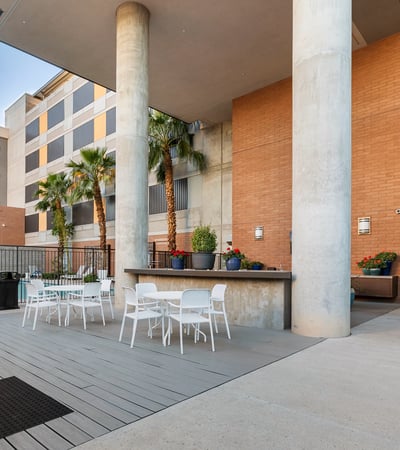 Outdoor patio with dining tables and grilling station, providing a functional space for gatherings in Phoenix.