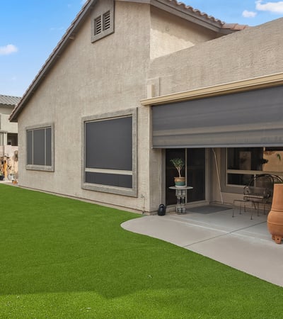Beautiful backyard with synthetic grass, low-maintenance landscaping, and open space for outdoor enjoyment in this Phoenix home.