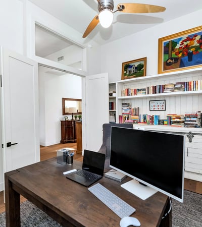 Home office with built-in bookshelves and storage, providing both style and practicality in this Phoenix residence.