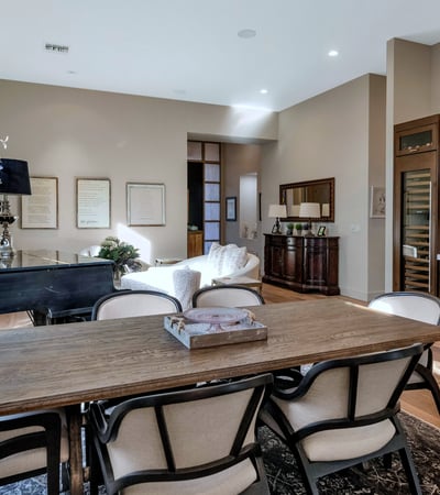 Stylish dining area with custom cabinetry, wine storage, and wood finishes, offering both function and elegance in this Phoenix home.