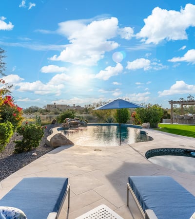 Scottsdale outdoor kitchen with pergola, built-in grill, and bar seating, creating a perfect space for entertaining guests.