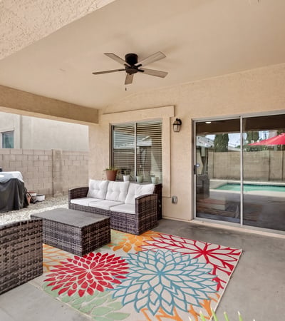 Outdoor living space with covered patio and seating area, perfect for relaxing or hosting. Easy access to the pool enhances the Casa Grande lifestyle.