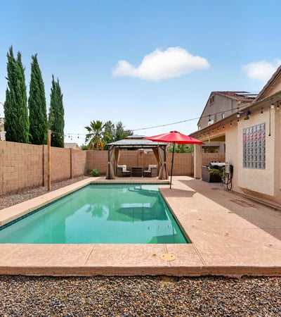 Inviting backyard with pool and low-maintenance design. Perfect for cooling off and entertaining in this Casa Grande home.