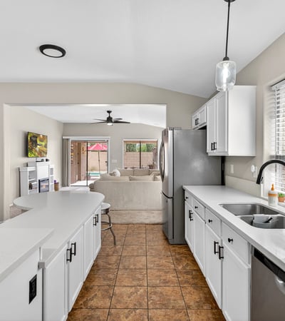 Well-designed kitchen with ample cabinets, stainless appliances, and extended counters. Open flow enhances functionality in this Casa Grande property.