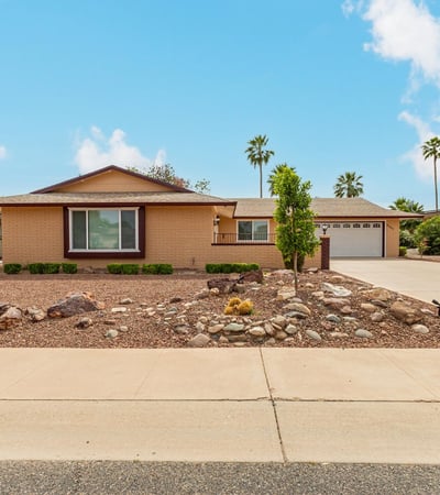 Wide driveway and open front yard offering plenty of parking and easy access. This Sun City home combines functionality with attractive desert landscaping.