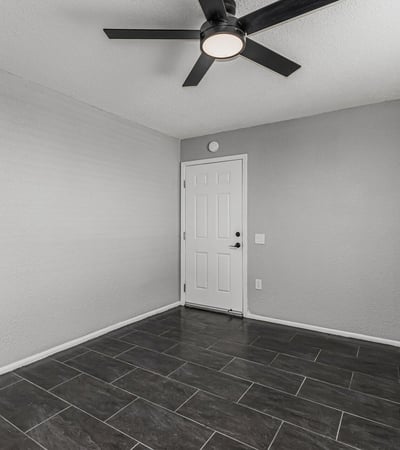 Flexible interior space with tile flooring and ceiling fan. This Sun City home provides options for office, guest room, or hobby area.