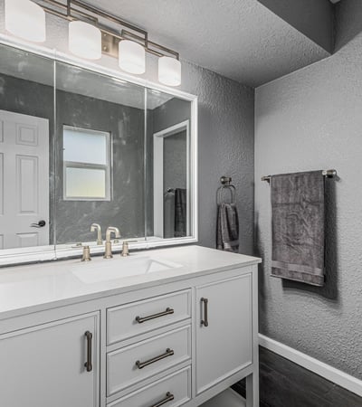 Updated bathroom vanity with sleek countertop, modern fixtures, and bright lighting. This Sun City home offers refreshed spaces with stylish upgrades.