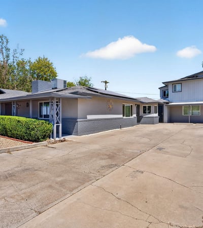 Oversized driveway offering easy access to multiple units, enhancing convenience and rental appeal in this updated Phoenix income property.