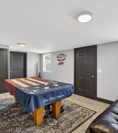 Large recreation room featuring a pool table and seating, offering a dedicated space for relaxation and entertainment.