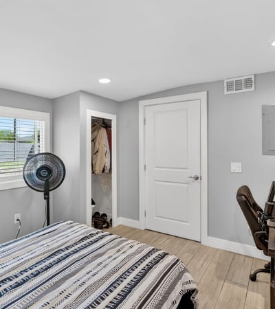 Light-filled bedroom featuring updated flooring, closet space, and a functional layout.
