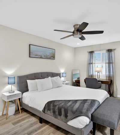 Bright and airy primary bedroom with modern flooring, workspace, and natural light designed for relaxation in this Scottsdale residence.