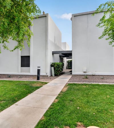 Attractive Scottsdale exterior with green lawn, mature trees, and clean design offering great curb appeal and community atmosphere.