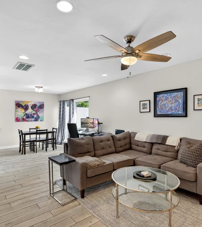 Light-filled Scottsdale living and dining space with open layout, modern finishes, and ceiling fan perfect for entertaining and daily living.