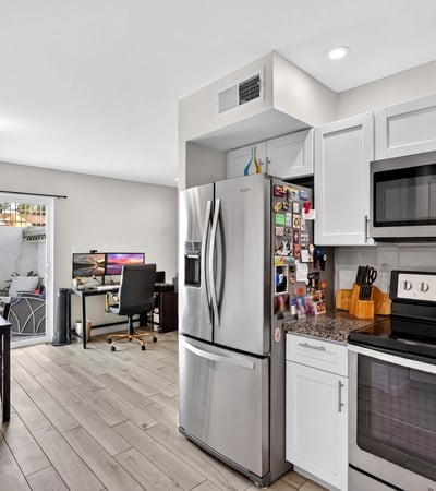 Functional Scottsdale kitchen and dining space with modern finishes, built-in workspace, and direct patio access ideal for everyday living and entertaining.