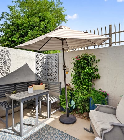 Scottsdale outdoor space featuring dining table, decorative elements, and lush plants for an inviting entertaining area.