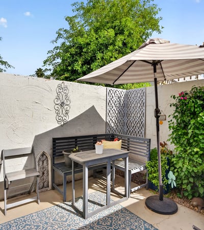 Comfortable Scottsdale patio with seating, shade, and garden accents, creating a warm and welcoming outdoor space.