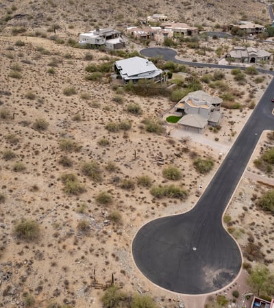 Expansive aerial view of this premium hillside lot surrounded by custom homes and breathtaking desert scenery. An ideal Phoenix location for building a luxury residence with mountain views.