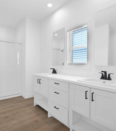 Beautiful primary bath featuring dual sinks, contemporary finishes, glass shower enclosure, and ample storage. Designed with comfort and functionality in mind, this space serves as a relaxing daily retreat.