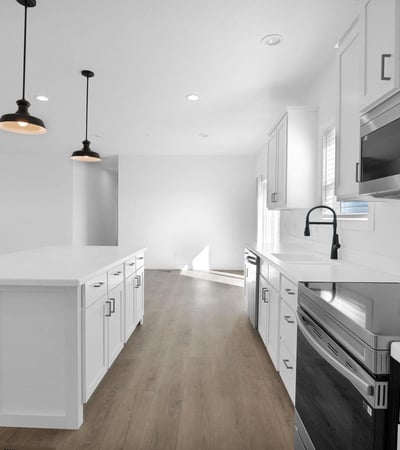 Expansive great room designed for modern living, offering generous square footage and seamless connection to the kitchen. The open-concept floor plan creates an inviting environment for entertaining and daily activities.