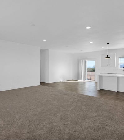Large open living area flowing effortlessly into the stylish kitchen. Featuring modern finishes, energy-efficient construction, and an oversized island, this design is perfect for both entertaining and daily comfort.
