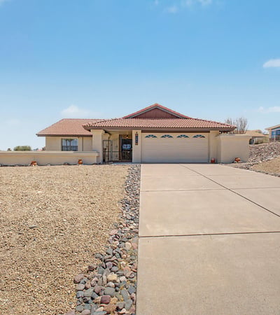 Wide-open views and desert landscaping frame this inviting Fountain Hills home. The expansive front yard and clean exterior presentation create a welcoming first impression for visitors and prospective buyers.