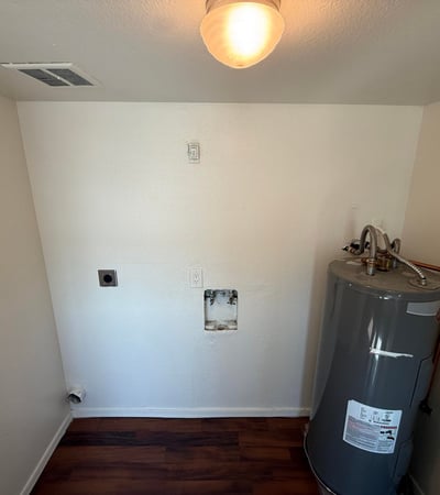 Interior utility room with washer and dryer hookups, dedicated laundry connections, and water heater access. This practical feature adds convenience and supports an efficient lifestyle.