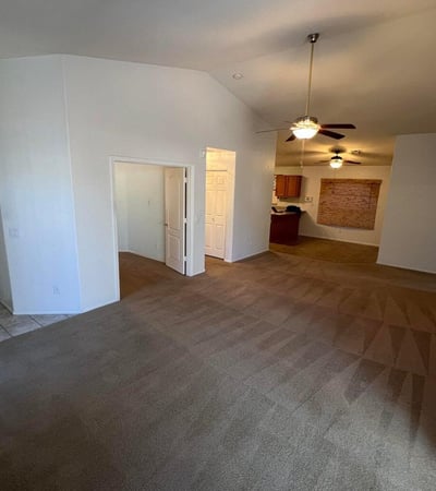 Open-concept great room featuring soaring ceilings and easy access to adjacent living spaces. The flowing floor plan creates a welcoming atmosphere perfect for modern living and entertaining.