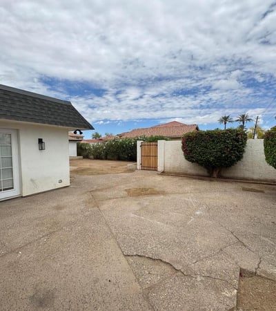 Open patio space offers a welcoming environment for outdoor gatherings, grilling, or relaxing evenings. Privacy walls and established landscaping create an enjoyable extension of the home's living space in Glendale.