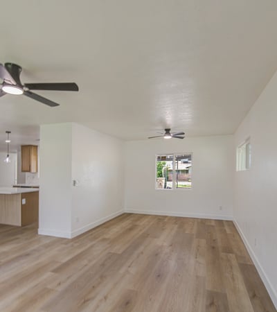 This spacious living room provides endless possibilities for entertaining or relaxing, enhanced by updated finishes, fresh paint, and beautiful natural light.