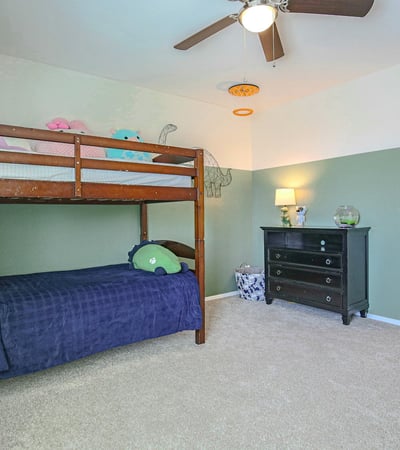 Well-appointed secondary bedroom featuring a walk-in closet, plush carpeting, and generous space for furniture. A versatile room designed for everyday comfort and organization.